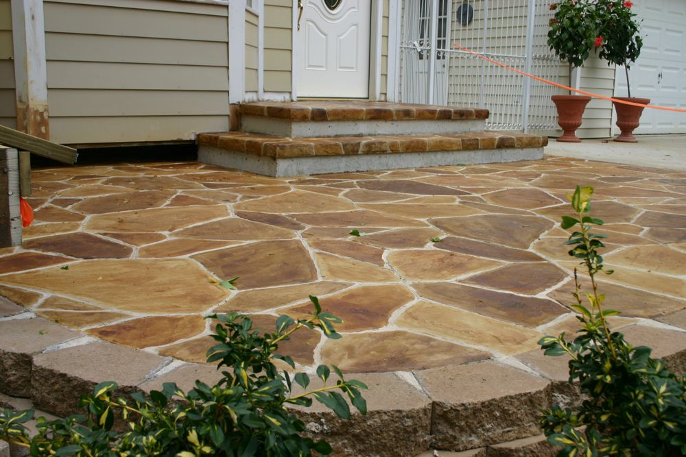 Skilled concrete contractors in Seagoville TX delivering custom stamped concrete entrance with flagstone pattern and professional stair construction.